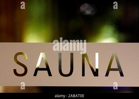 Sauna word on a glass door with blurred background Stock Photo