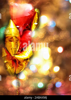beautiful multicolored balloons on dark background, isolated, with bokeh around, space for your text and design, blurred Stock Photo