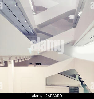 background blurred with tinting, Modern conceptual high tech building with abstract roof and stairs, Image contains excessive noise, film grain Stock Photo