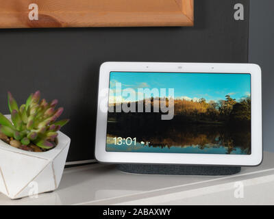 Nov 2019, UK - Google Nest Hub on fireplace showing picture and clock Stock Photo