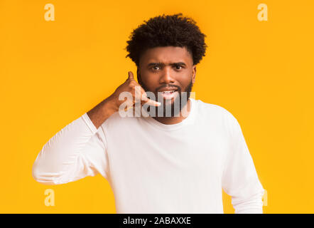 Single african guy making call me gesture Stock Photo