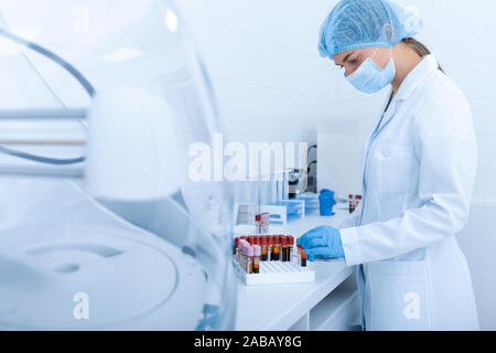 Woman collecting blood samples for testing on different diseases Stock Photo