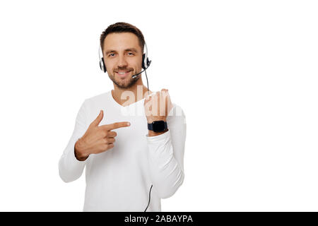 Call center worker man isolated on white background. handsome customer service representative with headset showing watch. Save your time - call customer service support