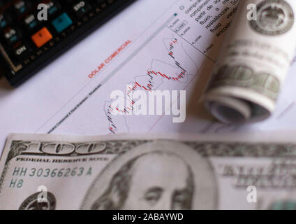 SÃO PAULO, SP - 26.11.2019: D'LAR SEGUE EM ALTA - Commercial dollar quotation charts next to US currency banknotes on Tuesday afternoon (26). The Real was one of the currencies that depreciated the most against the dollar. (Photo: Bruno Rocha/Fotoarena) Stock Photo