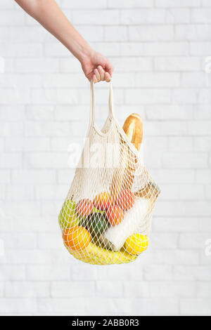 Eco cotton bag with natural vegetarian products in woman hand Stock Photo