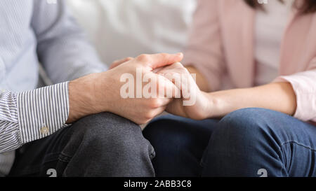 Man and woman holding hands, supporting each other Stock Photo
