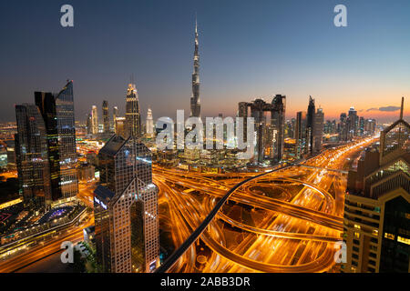 Skyline of Dubai, Sheikh Zayed Road and Burj Khalifa skyscraper at dusk in Dubai, United Arab Emirates Stock Photo