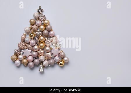Christmas tree made of silver pastel balls on grey background. Xmas composition. Flat lay, top view, copy space. Holiday Greeting card. Happy New Year Stock Photo