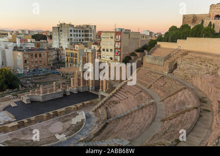 Aerial panoramic view of port city Cartagena in Spain with famous roman amphitheater. Beautiful sunset over the mountains. Wide angle lens panorama. Stock Photo