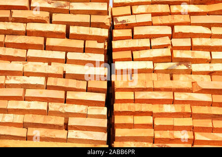 A pile of new bricks at construction site sitting on pallet Stock Photo ...