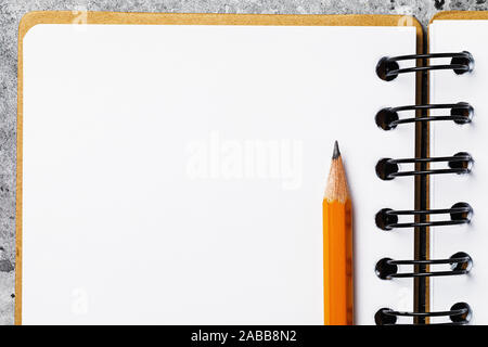A graphite pencil on a notebook with a copy of space, plan view Stock Photo