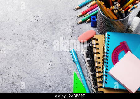 Different supplies for schoolchildren and students on the table with copy space. Top view on pencils, notebooks and rulers Stock Photo