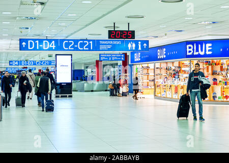 Passengers passing by Duty Free shops and boarding gates in the terminal of Vaclav Havel International Airport in Prague. Stock Photo