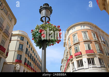 Looking up at the beautiful buildings from the main shopping streets in the city; Calle Larios and Calle Nueva, Malaga,  Andalusia, Southern Spain. Stock Photo