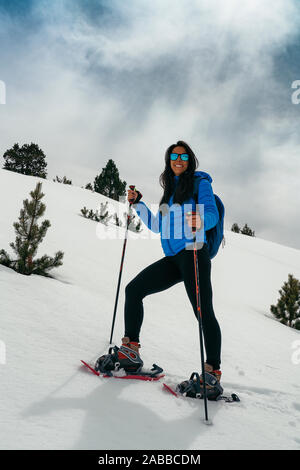 Young woman with snow rackets in high mountain Stock Photo