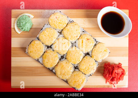Sesame roll with cheese caps. With ginger and wasabi. Stock Photo