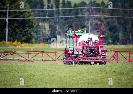 Annat, Canterbury, New Zealand, November 24 2019: A farmer sprays his crop in a farm field in springtime Stock Photo
