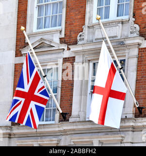 Displaying pristine British union jack flag of United Kingdom alongside National flag of England derived from Saint Georges Cross London England UK Stock Photo