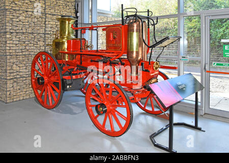 1880 historical Merryweather horse drawn fire engines on display in front of modern Gabion wall at Locomotion Railway Museum  Shildon County Durham UK Stock Photo