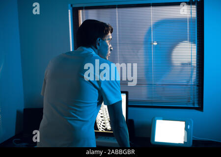 in the Medical Laboratory the Radiologist in the Control room Monitors the Skeleton and ribs of the patient MRI or CT Stock Photo