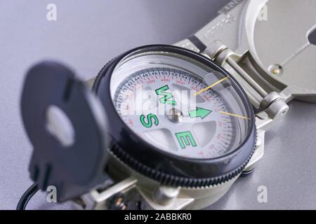 Close-up of military compass on a grey metal background Stock Photo