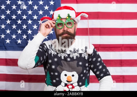 Have red white and blue christmas. Santa on american flag background. Bearded american man celebrate new year. Festive decorations with US flag. National flag. Stars and Stripes. Flag day. Born free. Stock Photo