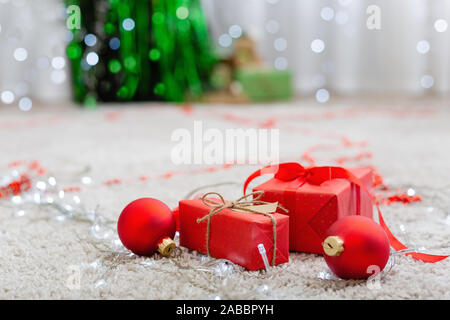 Small handmade gift boxes in shiny colorful night. Luxury New Year gift. Christmas gift. Christmas background with gift box. Christmas time celebratio Stock Photo