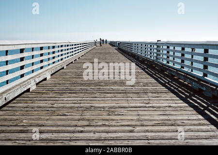 Blue skies and a long wooden pier in San Simeon, CA Stock Photo