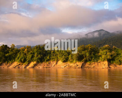 Landscape morning view of a mist rising over distant mountains while cruising on the Chindwin River in northwestern Myanmar (Burma) Stock Photo