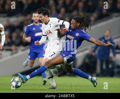 London, UK. 26th Nov, 2019. Tottenham Hotspur's Heung-Min Son (2nd R) is tackled by Olympiakos' Ruben Semedo during the UEFA Champions League Group B match at the Tottenham Hotspur Stadium in London, Britain on Nov. 26, 2019.FOR EDITORIAL USE ONLY. NOT FOR SALE FOR MARKETING OR ADVERTISING CAMPAIGNS. NO USE WITH UNAUTHORIZED AUDIO, VIDEO, DATA, FIXTURE LISTS, CLUB/LEAGUE LOGOS OR 'LIVE' SERVICES. ONLINE IN-MATCH USE LIMITED TO 45 IMAGES, NO VIDEO EMULATION. NO USE IN BETTING, GAMES OR SINGLE CLUB/LEAGUE/PLAYER PUBLICATIONS. Credit: Xinhua/Alamy Live News Stock Photo