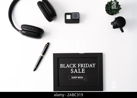 Black Friday Sale concept, Photo Frame, Action camera, Headphones, Pen, and Cactus, Black object on white background Stock Photo