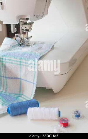 Sewing machine part, fabric, threads and accessories for sewing close-up Stock Photo