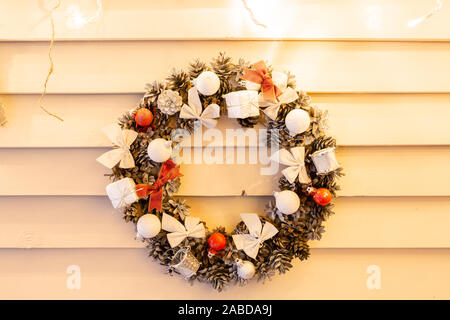 Beautiful Christmas wreath on wooden boards. Preparation for holidays concept. Flower shop is a master work of a professional florist. copy space Stock Photo