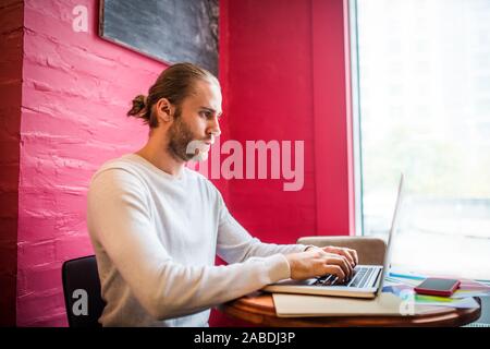 Bearded freelancer feeling busy while working having deadline Stock Photo
