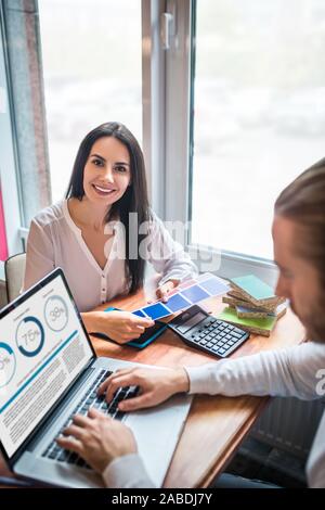 Couple of entrepreneurs feeling excited while opening their own business Stock Photo
