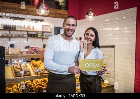Husband and wife opening their own pastry shop and thus feeling amazing Stock Photo