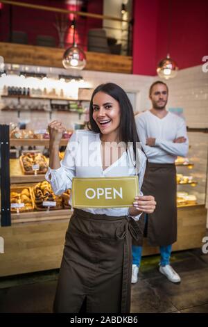 Woman wearing apron opening bakery with her successful husband Stock Photo