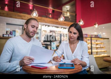 Two businessmen owning family business feeling busy with documents Stock Photo