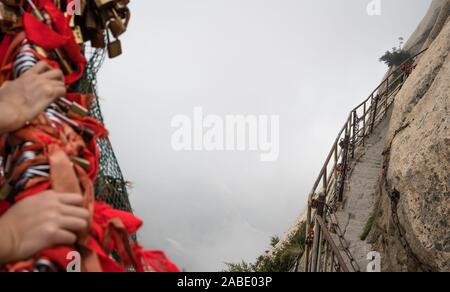 Stone steps cut on a side of a mountain rock leading to the dangerous and perilous Plank Walk trail, closed for public access due to bad weather condi Stock Photo