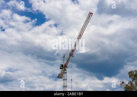 Hoisting crane against sky on the background. Building industry, development background Stock Photo