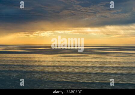 Spectacular sunset seascape with dramatic sky and colorful water Stock Photo