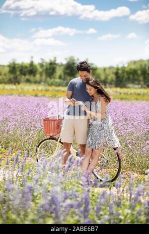 Happy young couple using smartphone Stock Photo