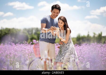 Happy young couple using smartphone Stock Photo
