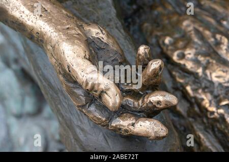metal hand open and ready to help or receive. Gesture hand hand of a statue outstretched for salvation. Stock Photo