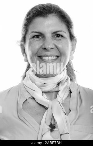 Face of happy mature businesswoman smiling in black and white Stock Photo