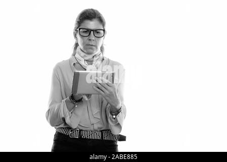 Studio shot of mature beautiful businesswoman using digital tablet Stock Photo