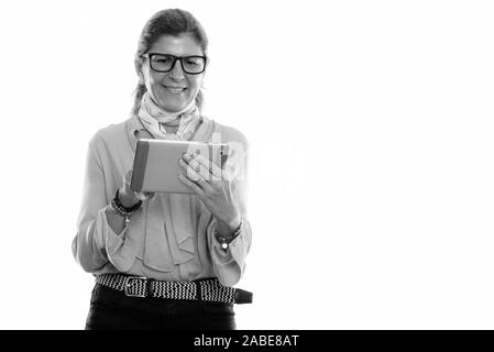 Studio shot of mature happy businesswoman smiling and using digital tablet Stock Photo