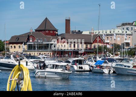 11 July 2019, Sweden, Strömstad: Motorboats are standing in the harbour of Strömstad on the Swedish west coast. Behind it is a fitness centre with a restaurant. Photo: Stephan Schulz/dpa-Zentralbild/ZB Stock Photo