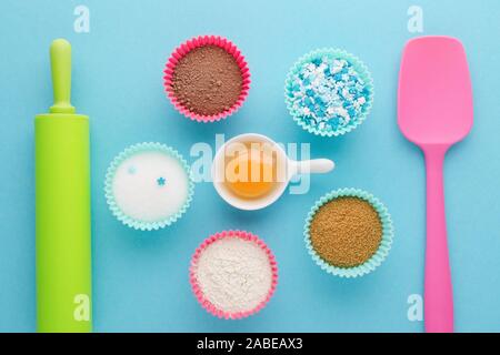 ingredients for baking and kitchen tools on blue background, flat lay Stock Photo
