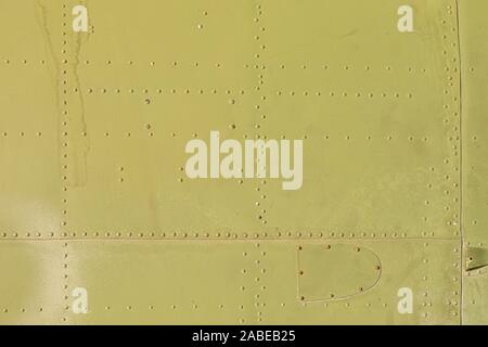 Old green metal surface of the aircraft fuselage with rivets Stock Photo